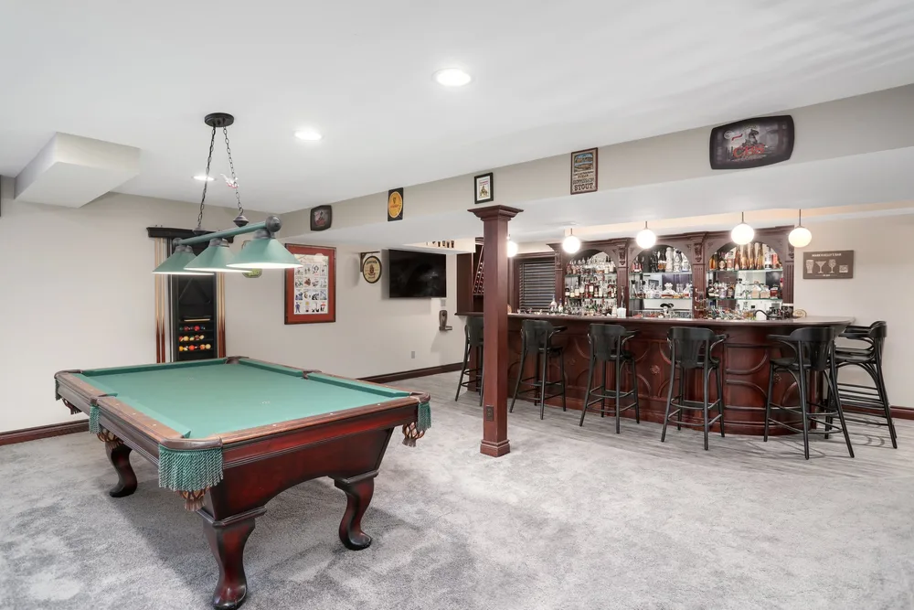Lower level billiards room in Brighton, MI by Lux Builders